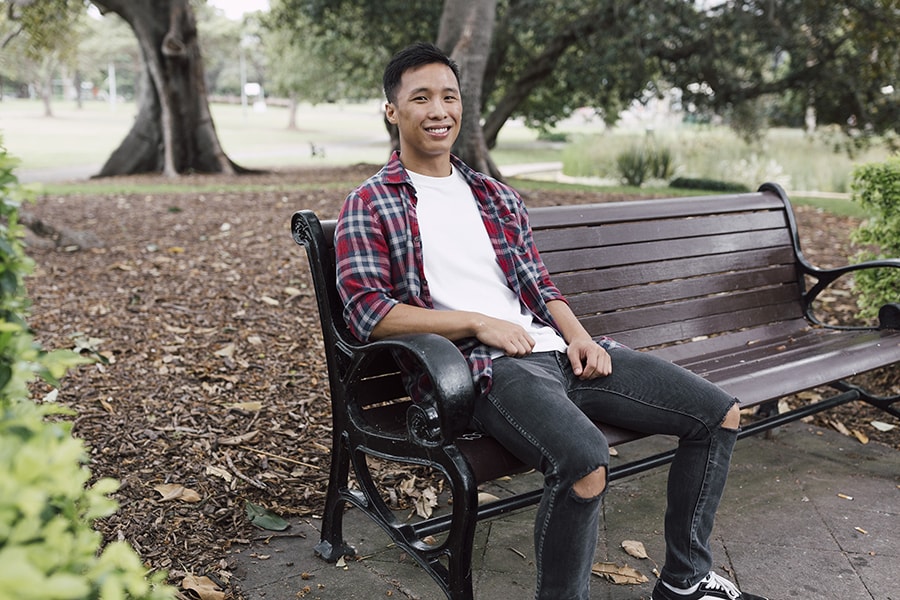 Young man sitting on park bench 2