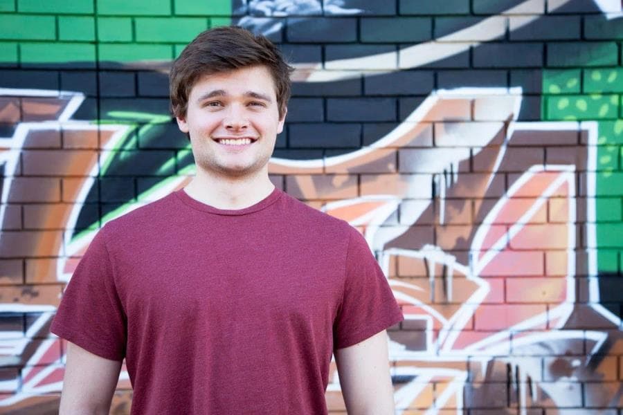 Young man in red shirt smiling